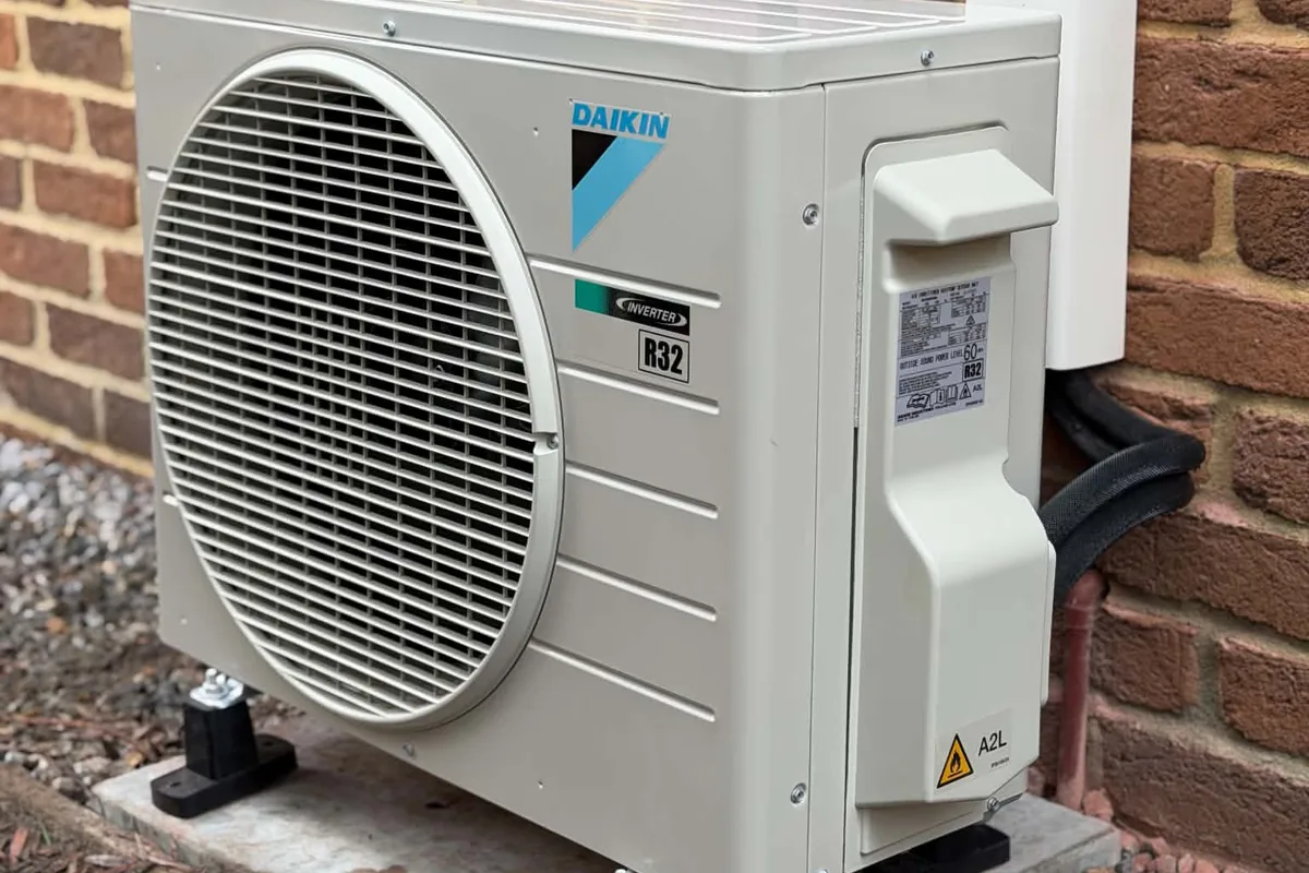 Daikin outdoor air conditioning unit against a brick wall